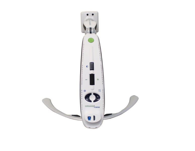The Transformer HD digital electronic magnifier base and back of device are in view.. A light green power button in found at at the top. A Dark gray contras button followed by a zoom toggle switch is found toawrds the center of the back. A Freeze and menu button are at the lower back as well as an ethernet and HDMI port