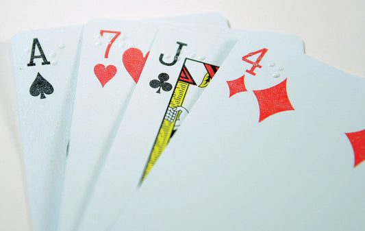 4 cards starting with Ace of spades, 7 of hearts, jack of clubs, and 4 of diamonds, with braille markings over the numbers