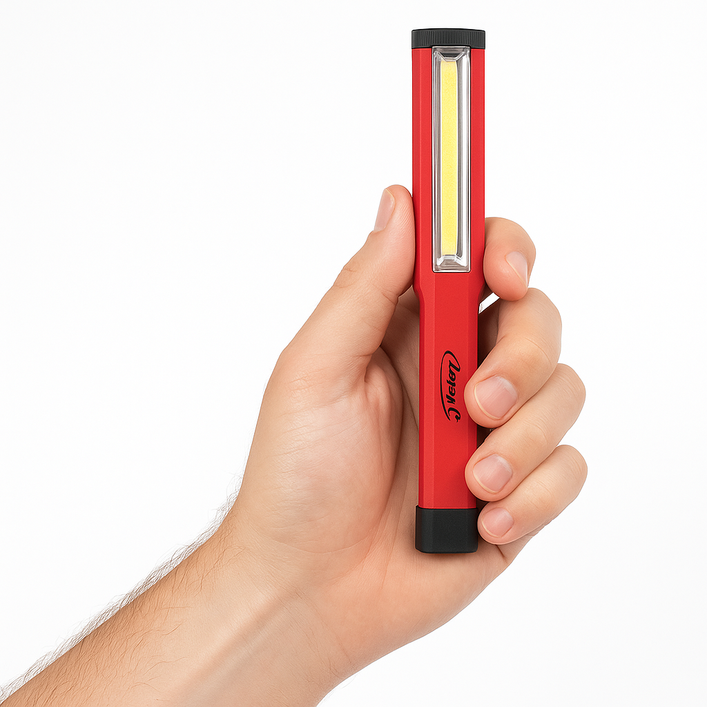 Close-up of a man's hand holding the Larry C COB LED Pocket Work Light with a transparent background